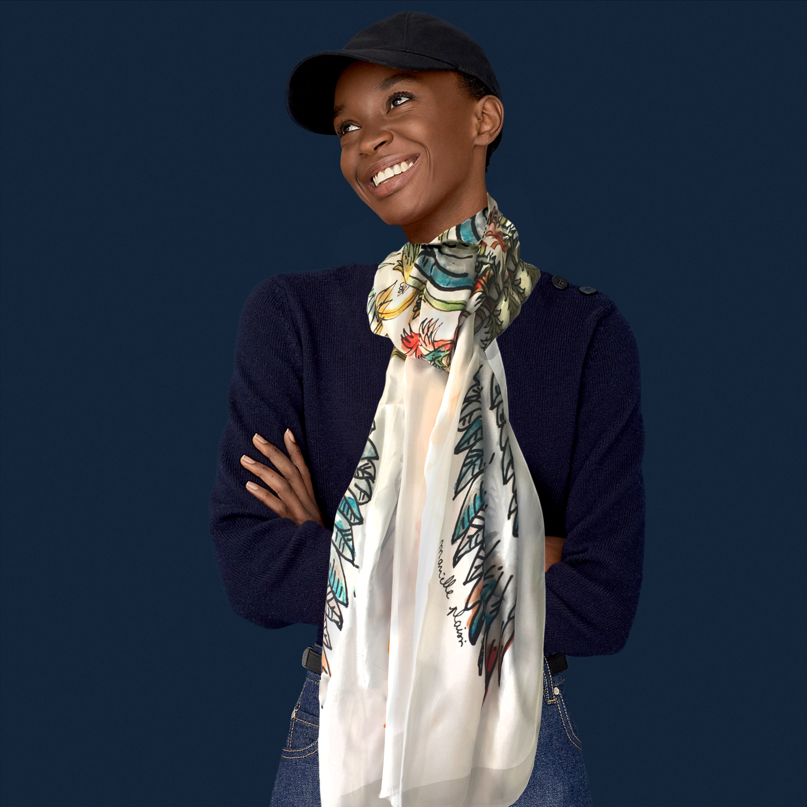 model wearing the white printed 100% silk scarf with the leaves and branches printed on it, in blues and oranges, yellows and reds.